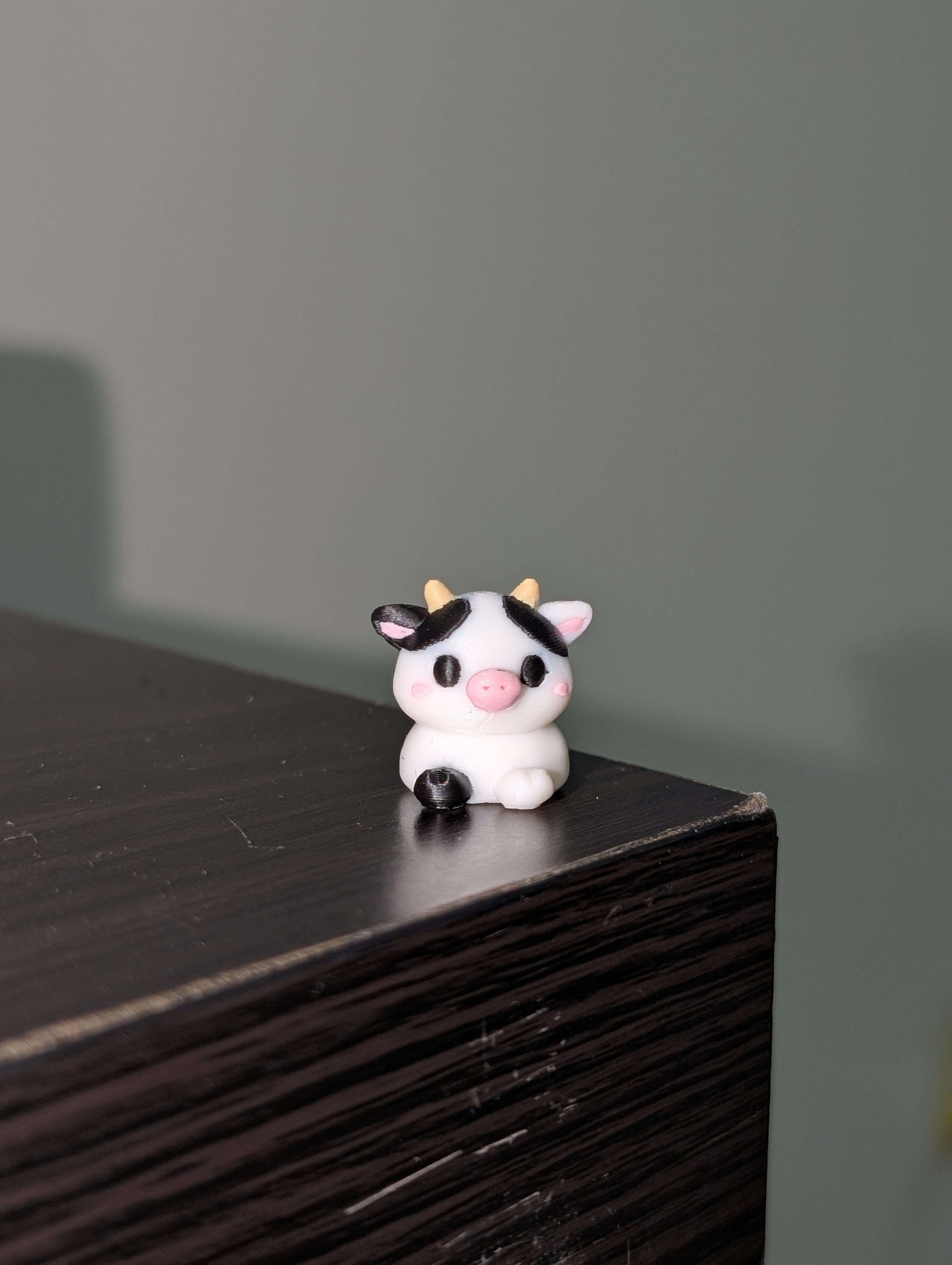 Small black and white collectible cow